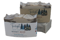 Three bars of soap with Twilight Soap Company packaging on a dark surface.