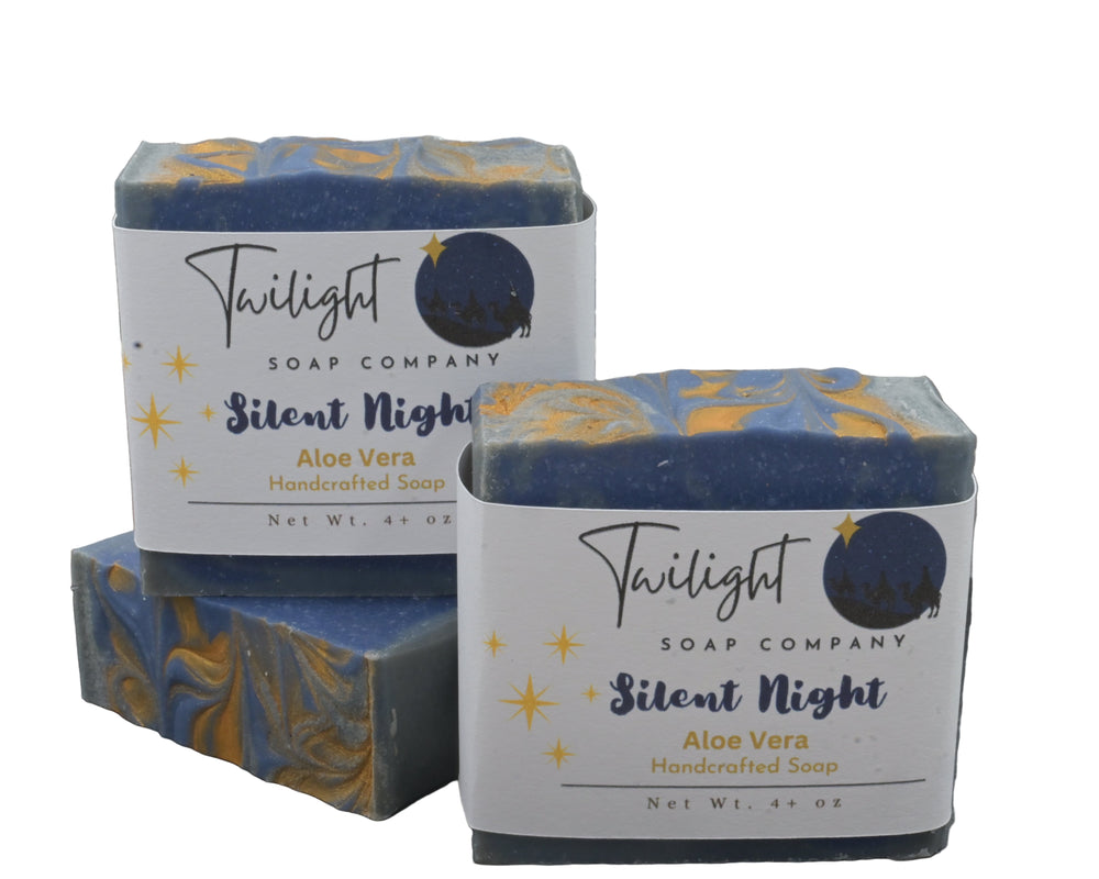 Two bars of Twilight Soap Company 'Silent Night' Aloe Vera soap on a dark surface with a textured gray background.