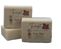 Two bars of Twilight Soap Company goat milk soap on a textured surface with a white background.