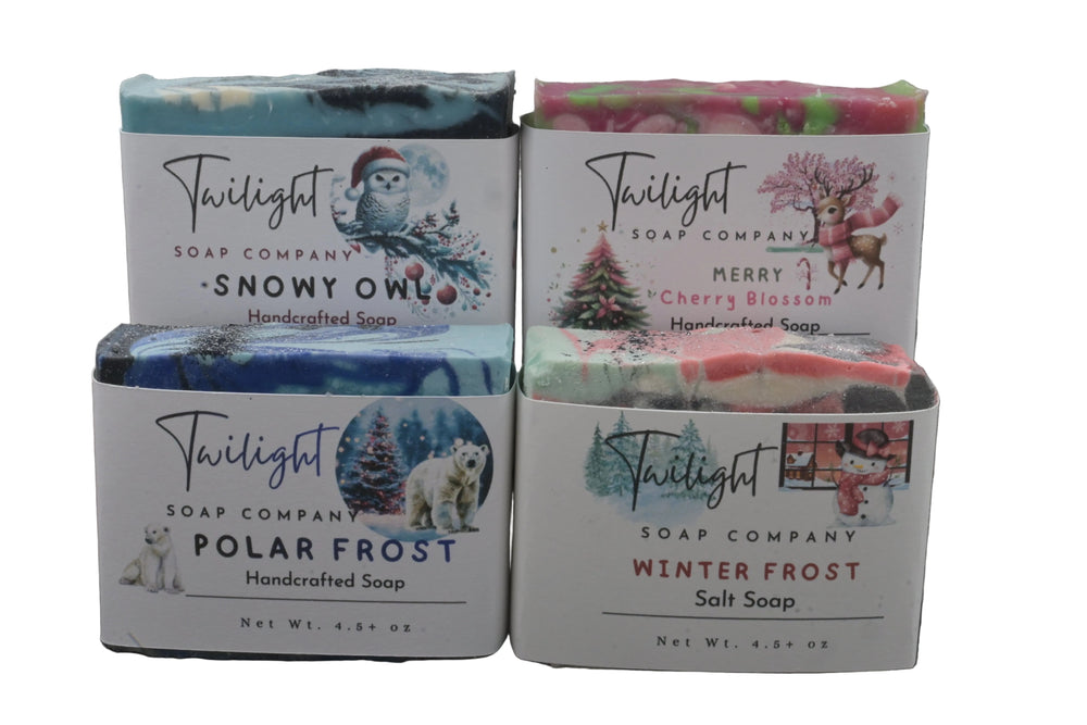 Four soap bars from Twilight Soap Company with decorative packaging on a neutral background