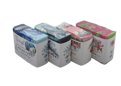 Five small containers with decorative labels on a dark surface.