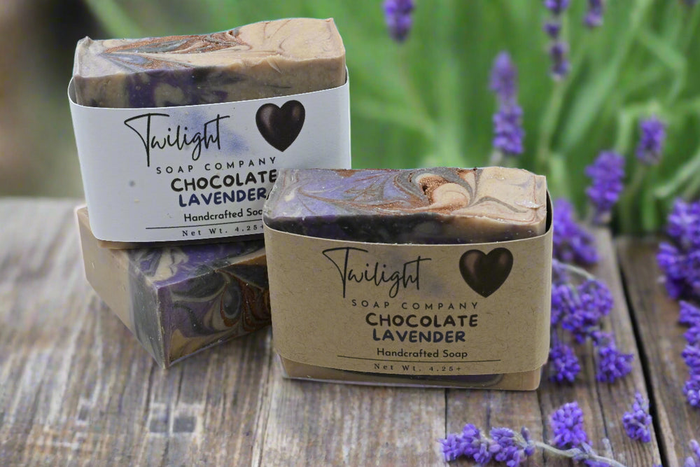 Two bars of Twilight Soap Company Chocolate Lavender soap on a wooden surface with a dark background.