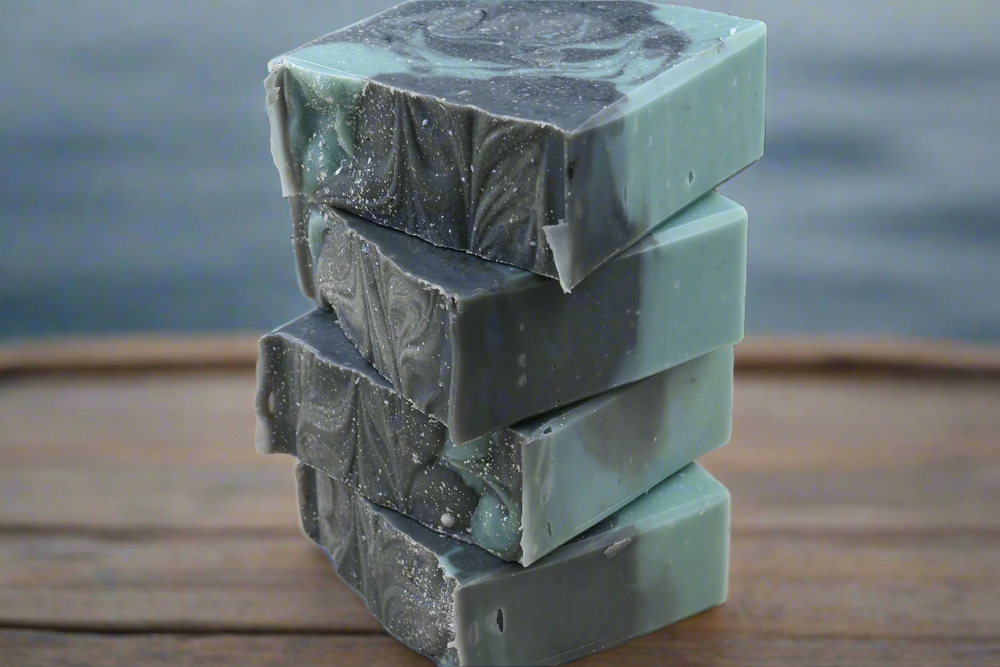 Stack of green soap bars on a wooden surface with a dark background