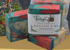 Colorful soap bars with a 'Twilight Soap Company' label on a dark surface