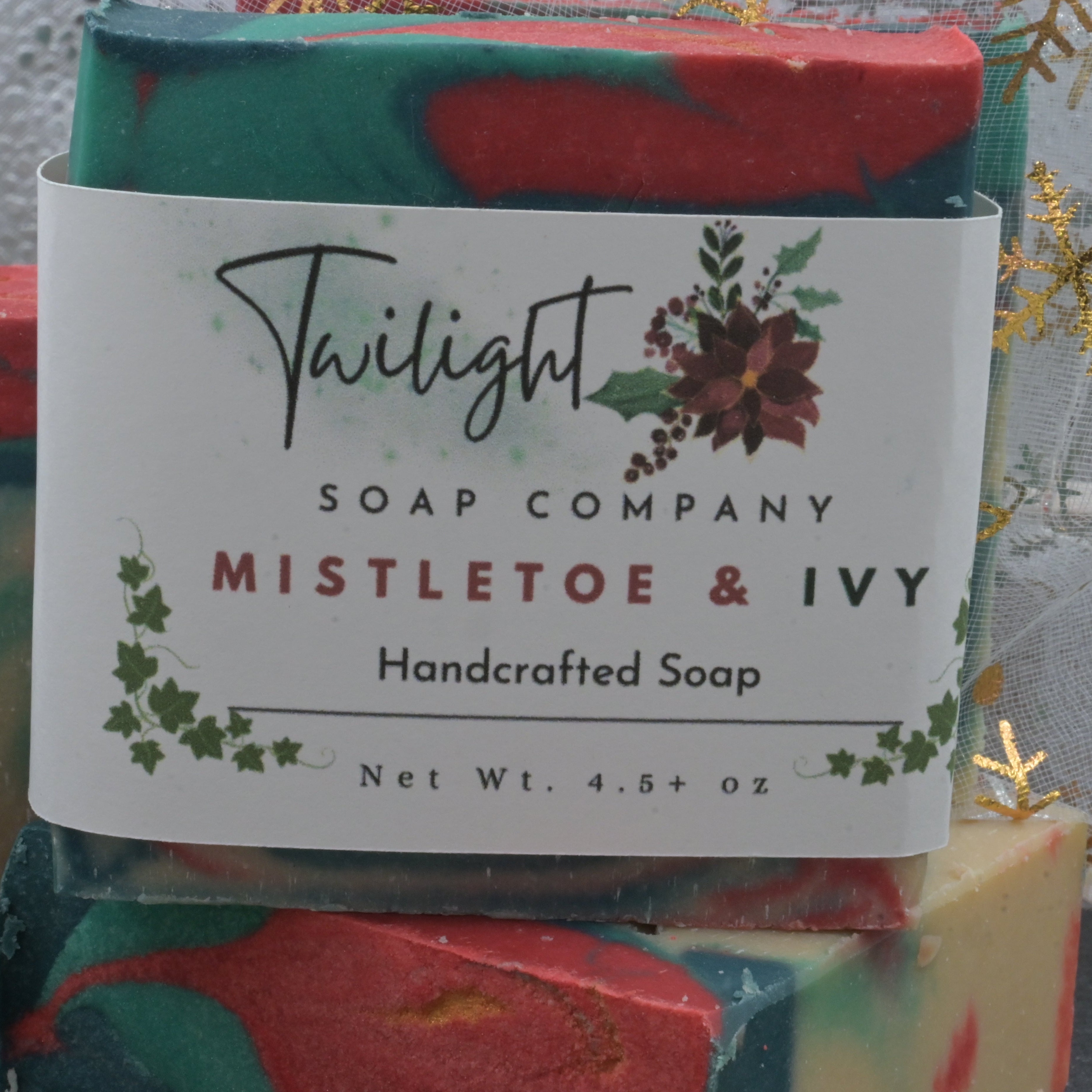 Colorful soap bar with a label from Twilight Soap Company, featuring 'Mistletoe & Ivy' design.