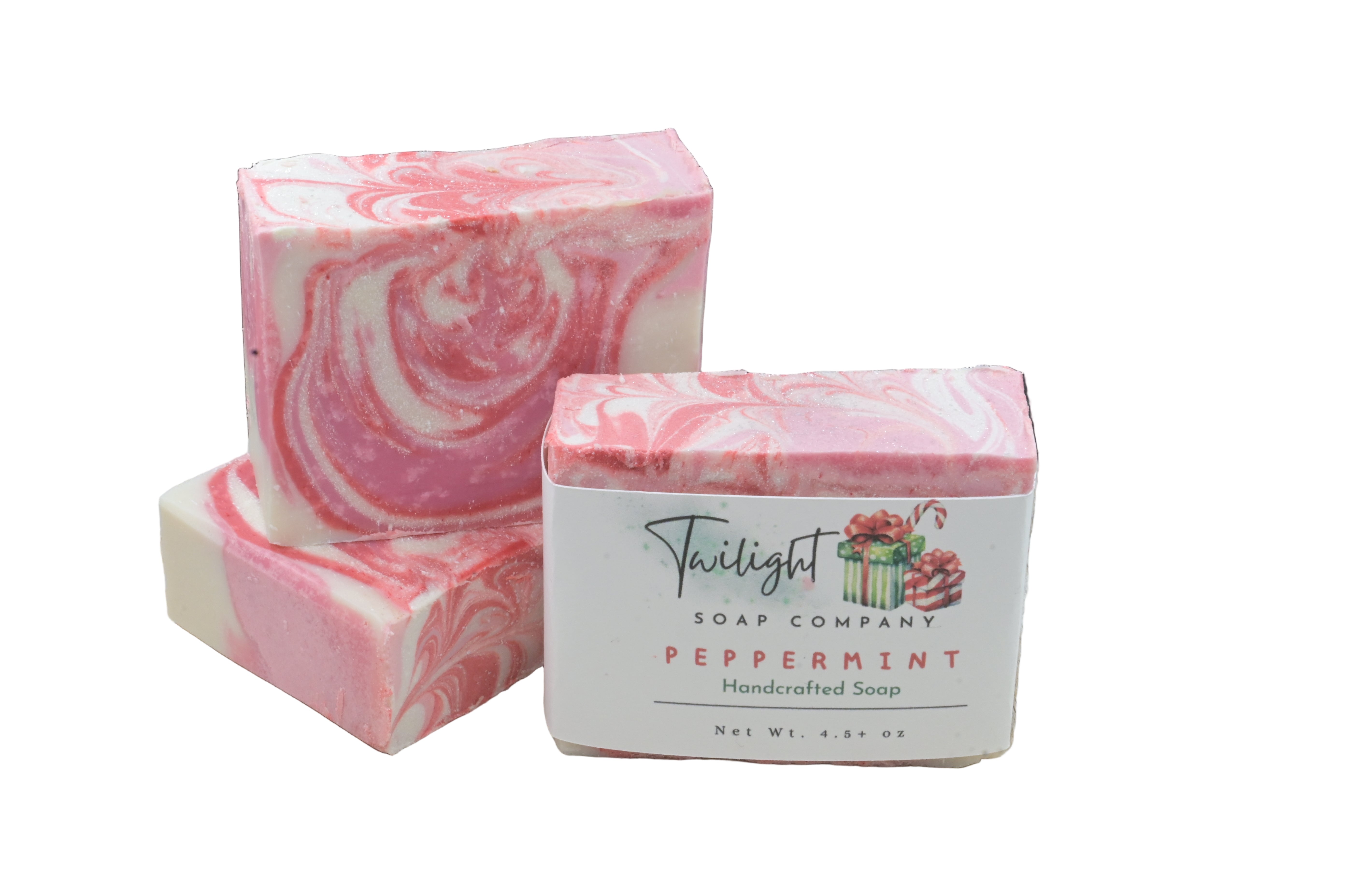 Pink and white swirled soap bars with a Twilight Soap Company label on a wooden surface.