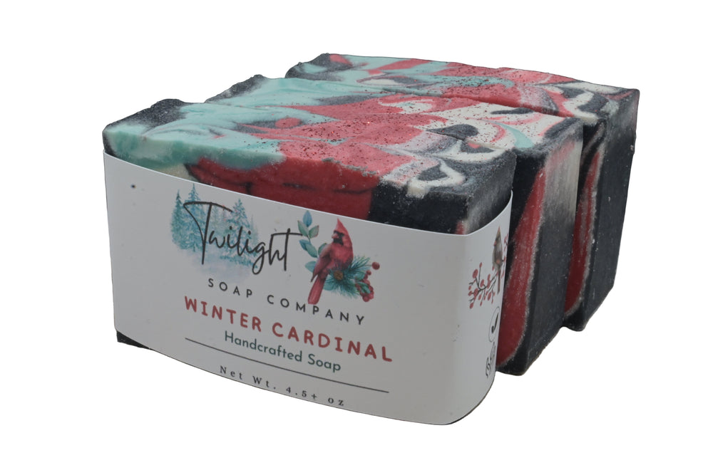 Handcrafted soap bar with a label from Twilight Soap Company on a wooden surface.