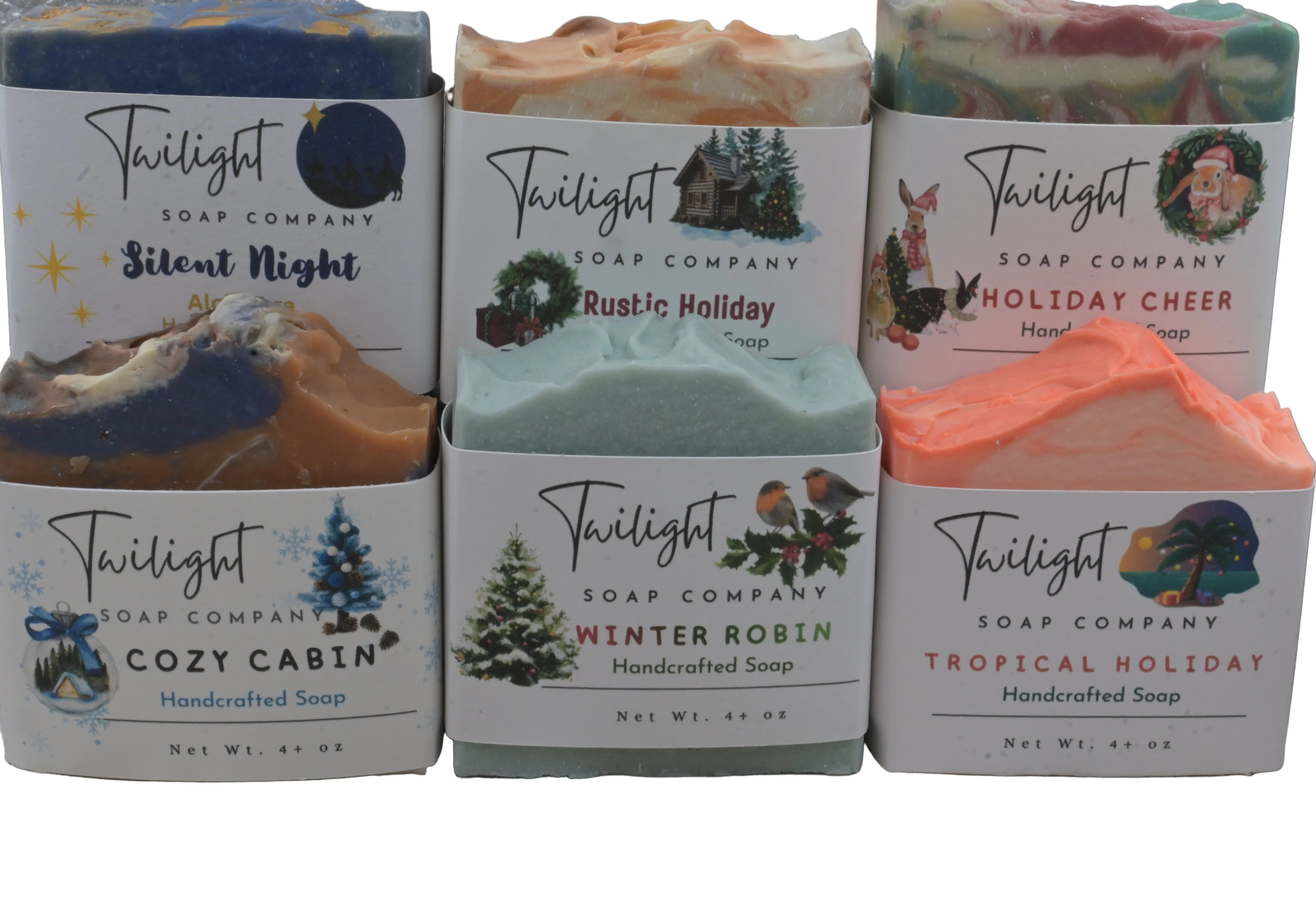 Collection of Twilight Soap Company soaps with seasonal designs on a wooden surface.