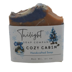 Handcrafted soap bar from Twilight Soap Company with 'Cozy Cabin' label on a wooden surface.